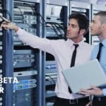 Two IT professionals managing server racks in a data center, optimizing the Hayward Beta Web Server for performance