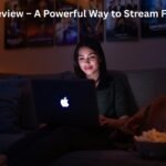 Woman watching movies online on laptop in cozy room, representing bflix pw free streaming experience.