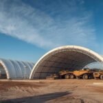 How Container Domes Are Transforming the Mining Industry: Durable, Cost-Effective, and Easy to Relocate Modern mining site with white container domes sheltering heavy equipment under a clear blue sky.
