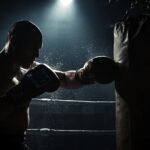 Demetris Fenwick: The Inspiring Rise of a Fighter Demetris Fenwick training hard with punching bag under spotlight in boxing ring