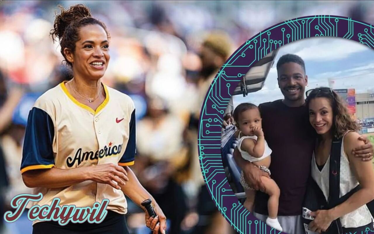 Elle Duncan smiling at a sports event with a family photo of her husband Omar Abdul Ali and their child featured beside her.