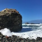 Stay in lodges by the beach with stunning ocean views and rocky cliffs