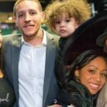 Caressa Suzette Madden with her partner Trey Songz and their child at a public event, all smiling and posing for the photo