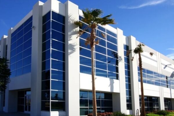 A modern commercial building with large windows and clean architectural design, showcasing the impact of commercial architectural design on business spaces.
