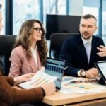 Team discussing effective marketing strategies for bariatric surgeons, focusing on data and patient outreach in a professional meeting