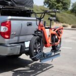 Electric bike mounted on a Hitch Bike Rack attached to a truck, ready for transportation