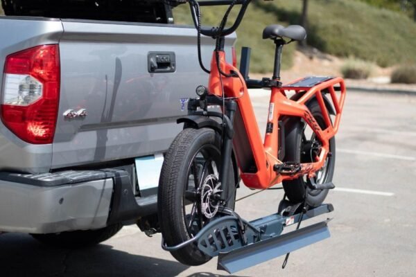 Electric bike mounted on a Hitch Bike Rack attached to a truck, ready for transportation