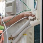 HVAC technician adjusting the air handler system, ensuring proper installation for optimal HVAC performance and energy efficiency