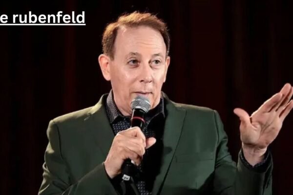 Luke Rubenfeld speaking on stage with a microphone, sharing insights as an experienced dog trainer and canine professional