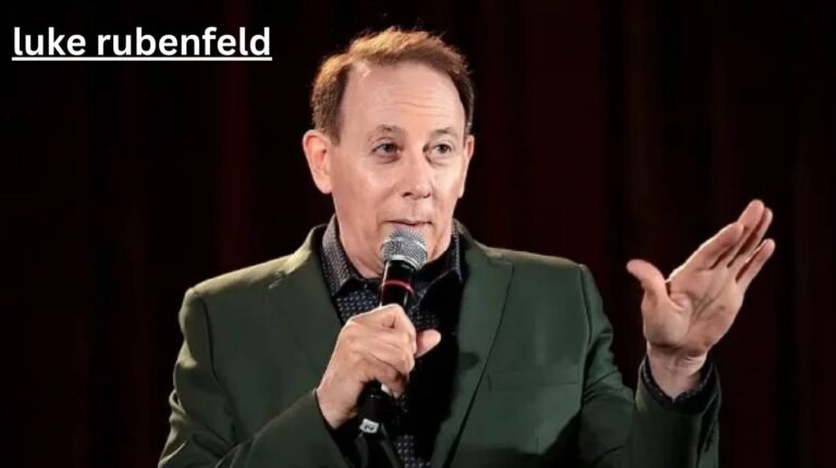 Luke Rubenfeld speaking on stage with a microphone, sharing insights as an experienced dog trainer and canine professional