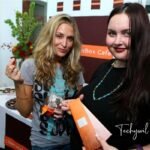 Paula Profit (left) at a Chocolat Box Café event, enjoying a chocolate treat with a guest while promoting her entrepreneurial ventures