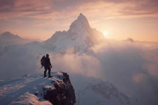 Climber stands at the peak of a snowy mountain during sunset, reflecting the challenges explored in the SEO optimization Arbicolix Mountain game review