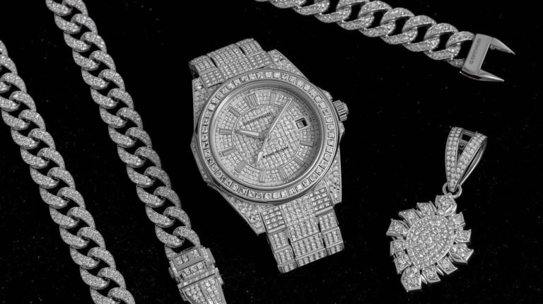 A collection of iced out jewelry featuring a diamond-encrusted watch, chain, and pendant, showcasing luxury accessories.