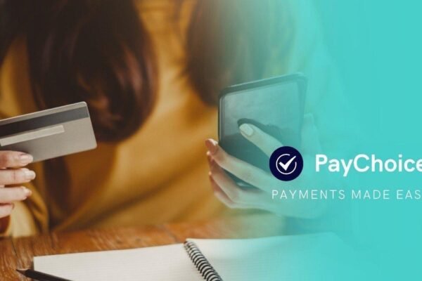 A person holding a credit card and smartphone, using PayChoice for seamless direct debit payments.