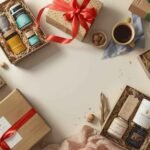 Several gift boxes filled with assorted gourmet items, jars, and packaged goods are arranged on a table, each box tied with a colorful ribbon. A cup of coffee and walnuts are also present.