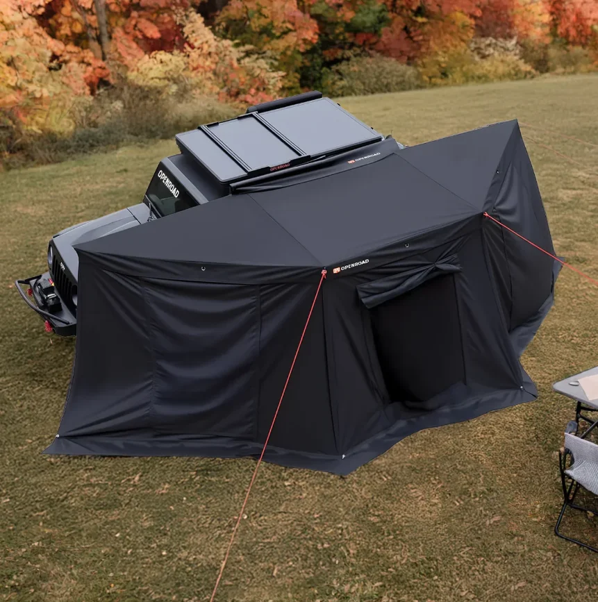 A tent accompanied by a table and chairs on grass, representing a car camping arrangement in the Car Camping Awning Guide.