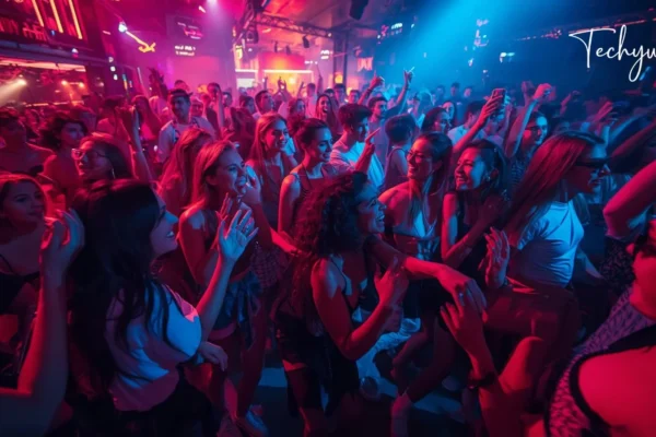 Crowd dancing in a neon-lit nightclub showing as sesta party se7enae vibe with energetic music and social atmosphere