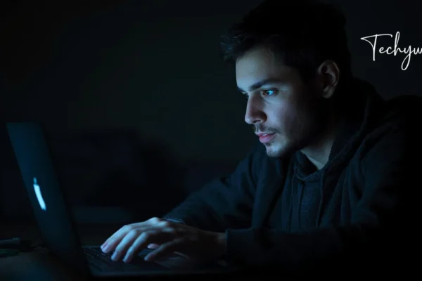 A man working late on a laptop in a dark room, reflecting search interest around lukman hakeem-mustafa seyal
